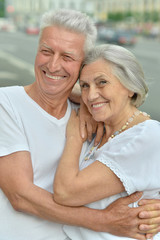 senior couple hugging outdoors