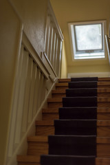 Oak stairs in old farm house with carpet runner and skylight