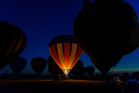 Hot Air Balloons Glowing At Night