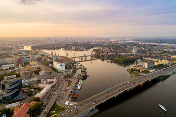 Obraz premium Panoramic aerial view of the old part of the city - Podol district. View of the Rybalsky Island at sunset.
