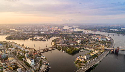 Obraz premium Panoramic aerial view of the old part of the city - Podol district. View of the Rybalsky Island at sunset.