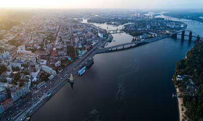 Fototapeta premium Panoramic view of a modern city with a river, unfinished bridge and park part of the city