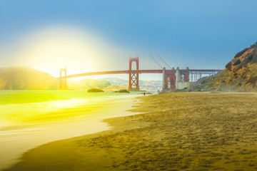 Spectacular view of Golden Gate Bridge from Baker Beach at sunset on popular Baker Beach.Holidays, travel and leisure concept. San Francisco, California, United States.