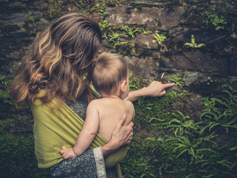 Mother teaching baby about nature by pointing