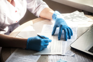 The doctor fills the patient's medical record