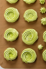 Home baked green meringues cookies. Top view