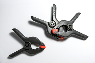 Black clamps on white background