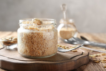 Cooked quinoa in glass jar on wooden kitchen table