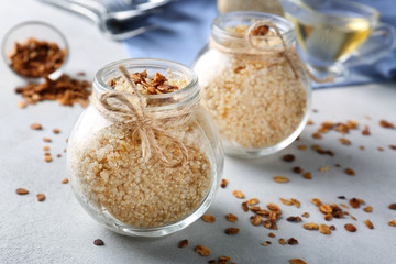 Composition with cooked quinoa and granola on grey background