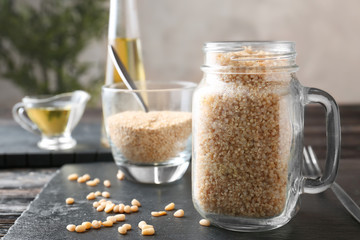 Cooked quinoa in glass jar on kitchen table