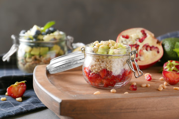 Fruit salad with quinoa served in glass jar on kitchen table