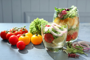 Vegetable salad with quinoa served in glassware on kitchen table