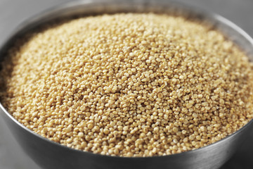 Raw quinoa in metal bowl, closeup