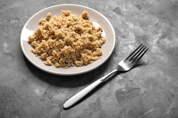 Cooked quinoa on grey background