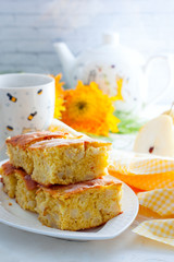 Home pear charlotte on a white dish, selective focus