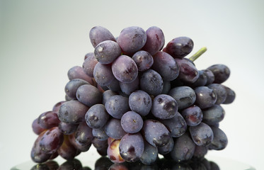 Bunch of fresh ripe dark red grapes.