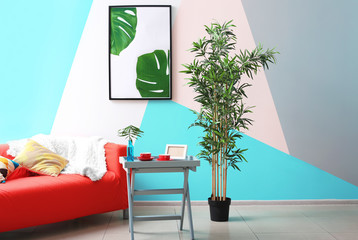 Modern living room design with framed picture of tropical leaves