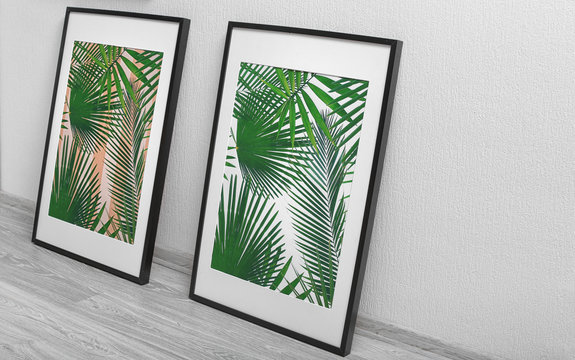 Framed pictures of tropical leaves on white wall background