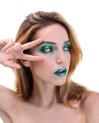 Young woman with bright green makeup on white background