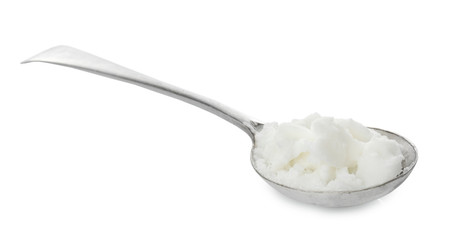 Metal spoon with coconut oil on white background