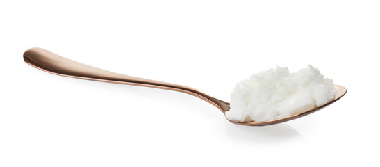 Metal spoon with coconut oil on white background