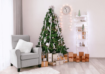 Decorated room with beautiful Christmas tree and gifts