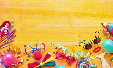 Carnival accessories against wooden background - obrazy, fototapety, plakaty