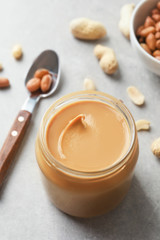 Glass jar with peanut butter on kitchen table