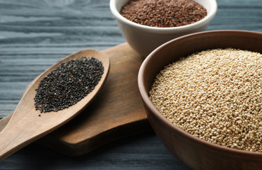 White, red and black quinoa in dishware on kitchen table