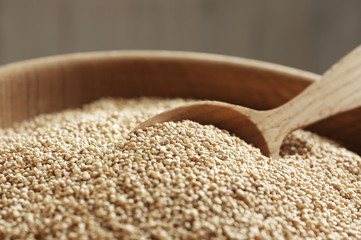 White quinoa in wooden bowl, closeup