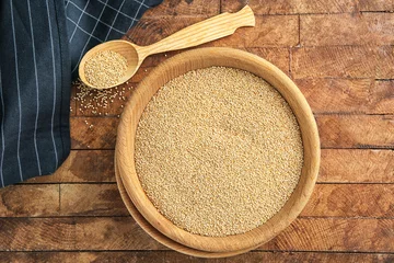 Foto auf Acrylglas White quinoa in bowl and spoon on wooden background © Africa Studio