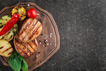 Composition with tasty grilled steaks on table