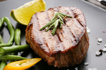 Tasty grilled steak on table, closeup