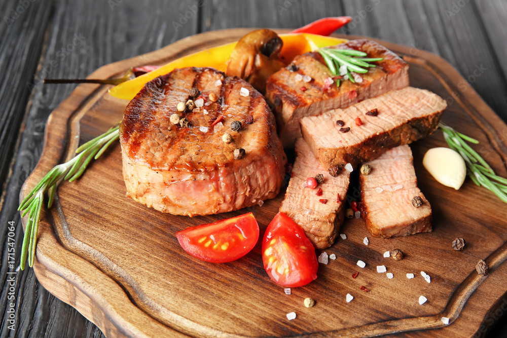 Canvas Prints Composition with delicious steaks and vegetables on table