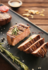 Plate of delicious steak on table, closeup