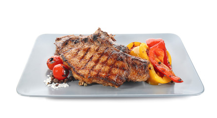 Plate with tasty grilled steaks and vegetables on white background