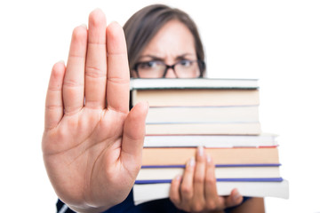 Selective focus student girl holding books showing stop