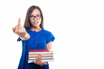Portrait of student girl holding books showing middle finger