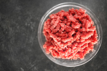 Bowl with fresh forcemeat on table