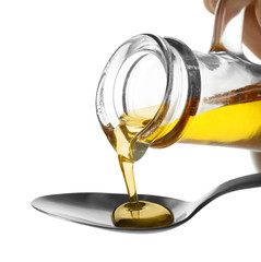 Pouring cooking oil into spoon on white background, closeup