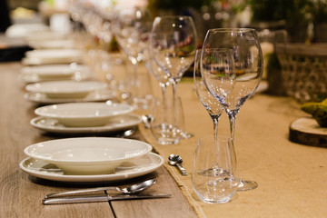 Table setting decor with cutlery, plates and glasses