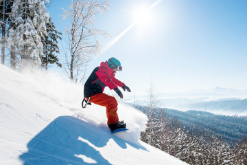 Shot of a freeride snowboarder riding in the mountains wearing snowboarding gear beautiful scenery...