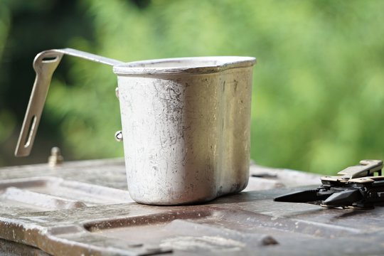 Canteen cup and multi tool on plate.