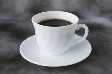 Cup with coffee on a dark background