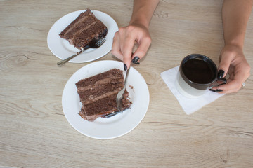Coffee cup and chocolate cake onon wooden table