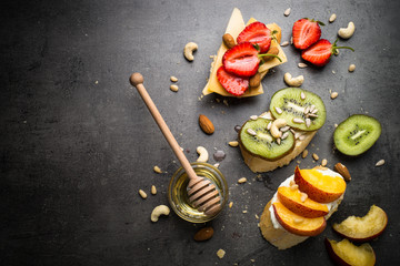Fresh sweet fruit sandwiches on black.