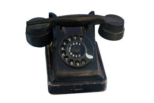 Old vintage black telephone isolated on white background