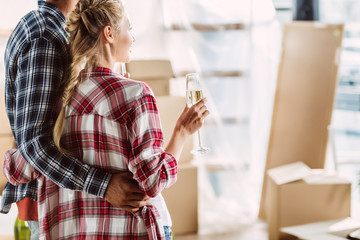 couple drinking champagne in new house