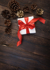 gift box with red ribbon on a wooden background