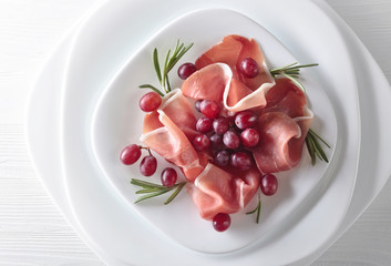 Jamon serrano with rosemary and grape .